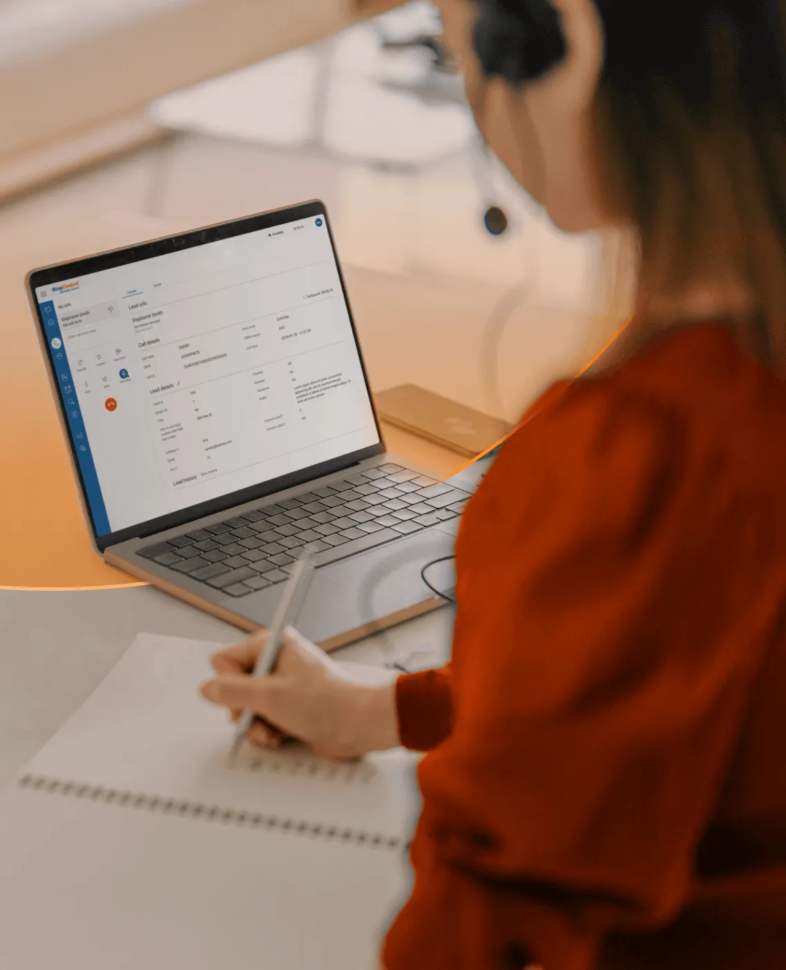 A female agent taking notes from her RingCentral app open on her laptop