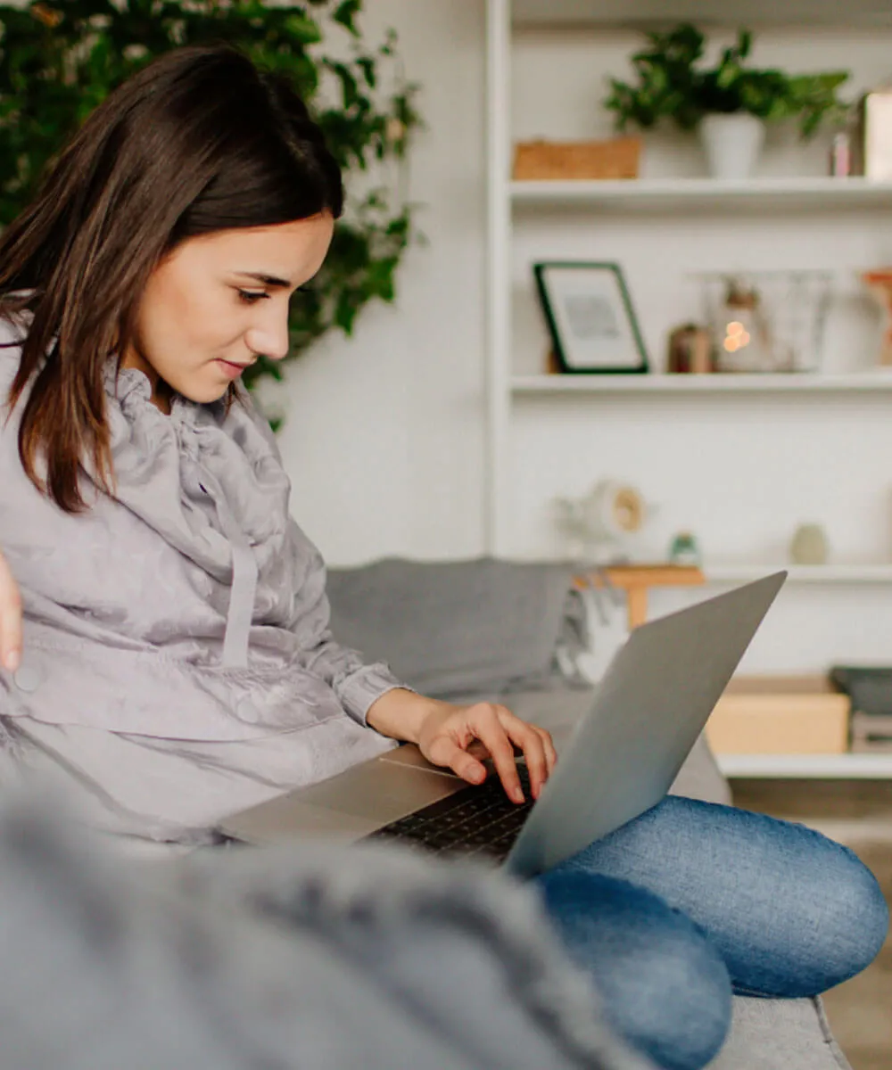 A woman using web conferencing in a meeting to share her small business website