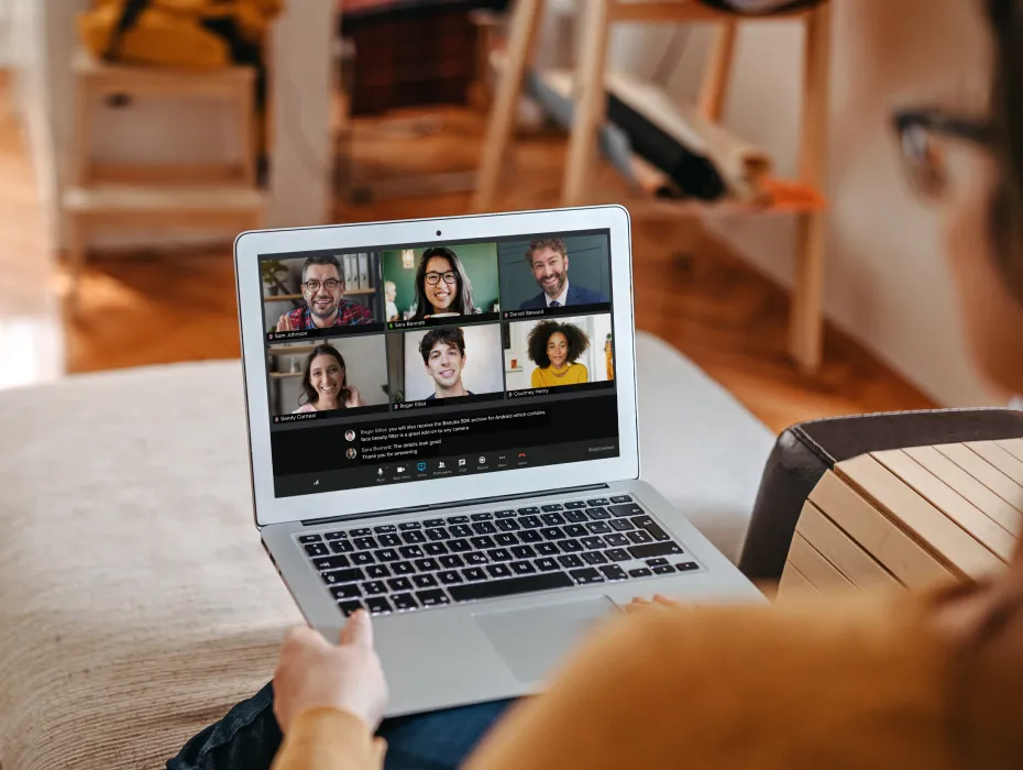 A manager on a RingCentral Video video meeting with her team while at home