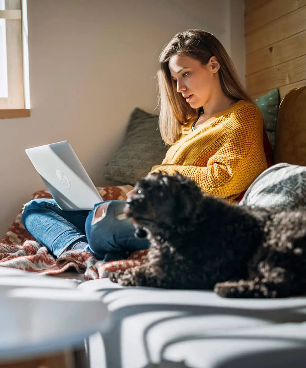 A woman using internet phone in her laptop