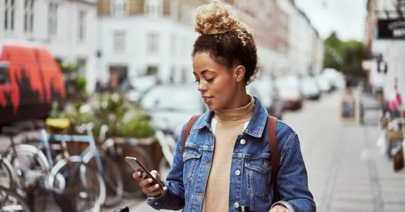 A woman using internet phone in her smartphone