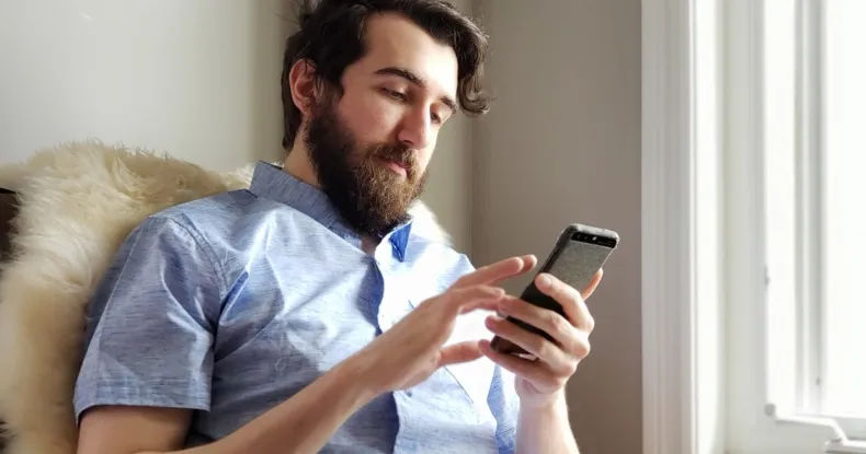 A modern man using mobile connection reach calling video calls chatting technology working from home