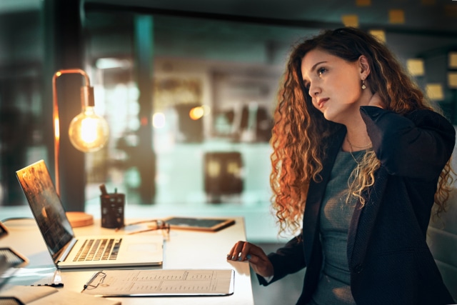 Shot of a businesswoman suffering burnout while working from home