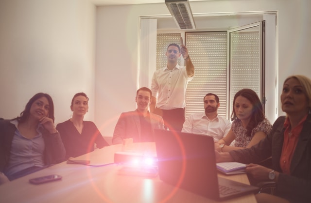 public sector business team in meeting room watching video presentation