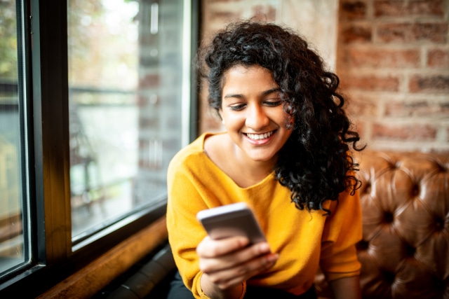 Woman using social media on mobile phone