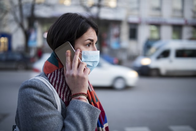 photo of a Young Woman With Face Mask Talking On The Phone.