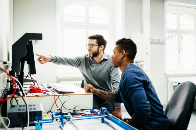 Engineering Tutor Helping Student During Teaching Session-724