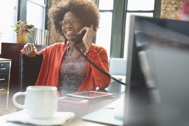 woman on the phone in the office at her desk.jpg