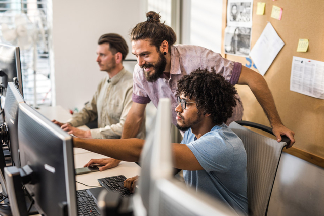 Male programmers cooperating while working on computer codes in the office.-949