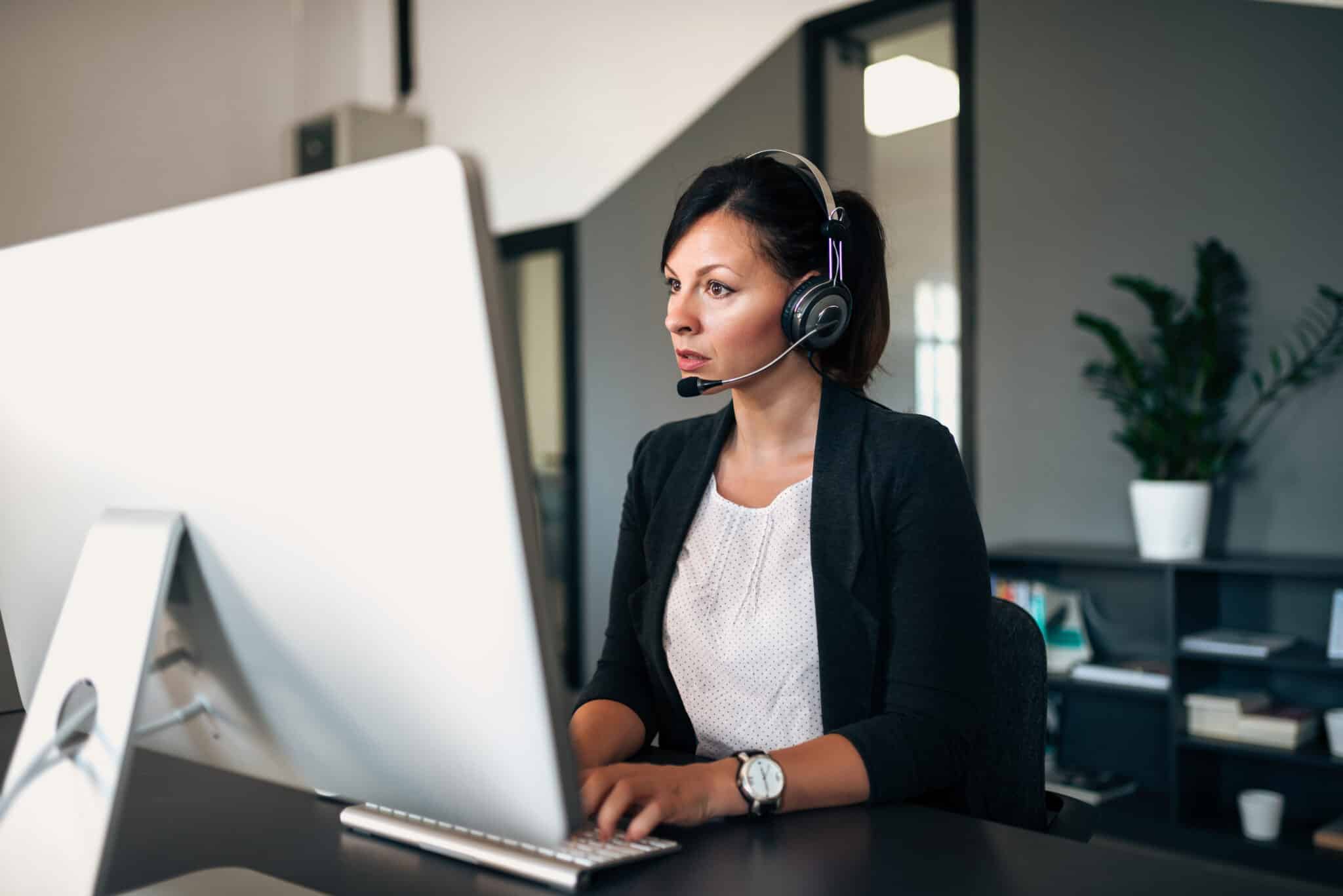 Photo of an agent wearing a headset, perhaps as part of an omnichannel contact center team