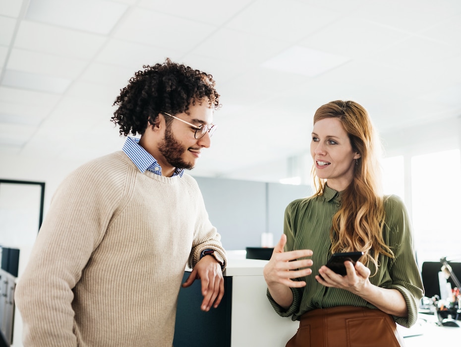 A partner showing an employee something On Smartphone