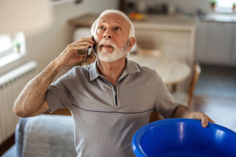 Person exemplifying business agility by coordinating tasks over the phone during a home issue