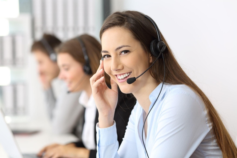 Woman at work showcasing business agility through effective communication on a headset