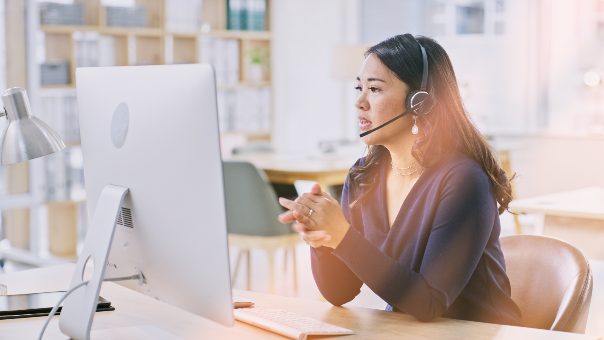 RingCentral bolsters RingEX with new customer engagement solutions Contact center rep woman on computer helping customer on headset